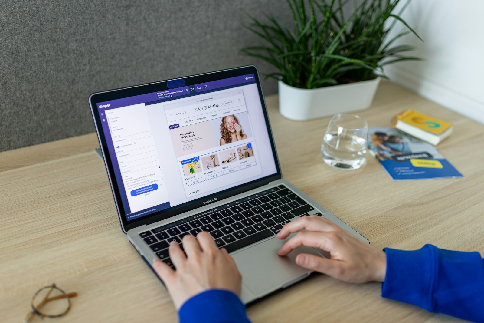 Merchant at a laptop viewing an online-store admin-style dashboard